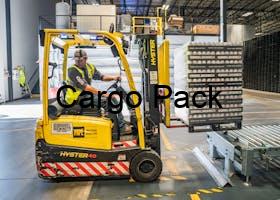 A warehouse worker maneuvers a forklift to transport crates for brewing company storage.